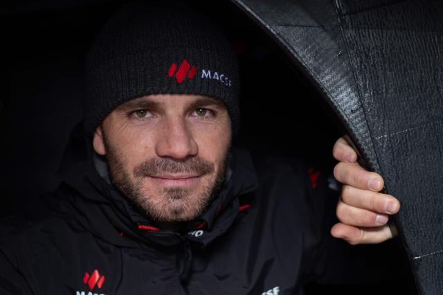 French skipper Corentin Horeau poses for a photograph aboard his Imoca class boat "MACSF" a week ahead of the start of the 13th Route du Rhum solo sailing race from Saint-Malo to Pointe-a-Pitre, in the French West Indies island of Guadeloupe, on October 24, 2026. (Photo by Sebastien Salom-Gomis / AFP)