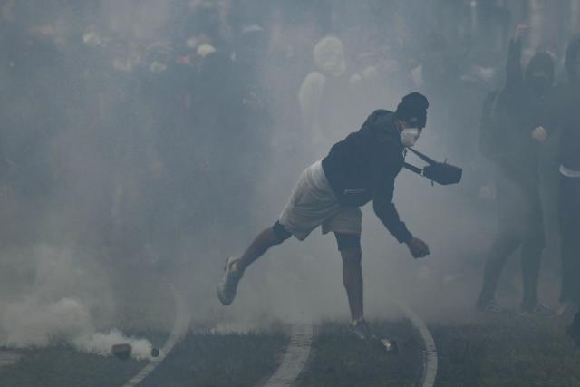 Protesters clash with police near Place de la Bourse, in a protest ban zone, as part of a demonstration in favor of purchasing power, the protection of public services, and fiscal and social justice, in Bordeaux, western France on October 24, 2026 as part of a nationwide call for mobilisation bringing together former members of the Yellow Vest movement, labor unions, high school and university students. Protests by high school students over learning conditions sparked a movement that has since spread nationwide, fuelled by broader anger over the rising cost of living. About 70,000 security personnel will be deployed on October 24, 2026, Interior Minister said at a news conference, warning that calls for violence and looting were circulating on social media. (Photo by Philippe LOPEZ / AFP)