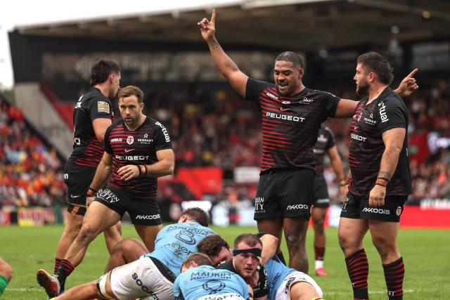 Toulouse's French hooker Peato Mauvaka (2R) celebrates after Toulouse's Irish lock Joshua Brennan (FRONT) scores a try during the French Top14 rugby union match between Stade Toulousain and USA Perpignan at the Ernest Wallon Stadium in Toulouse, southwestern France, on October 24, 2026. (Photo by Valentine CHAPUIS / AFP)