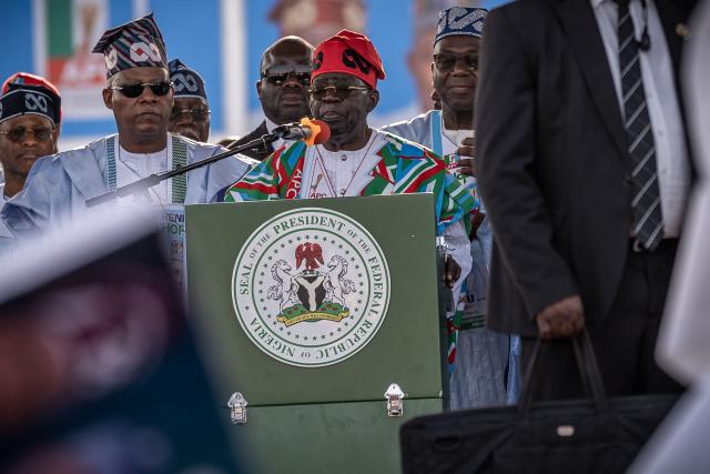 Bola Ahmed Tinubu (C), Nigeria's President, addresses supporters as Kashim Shettima (2L), Vice president of Nigeria looks on during the All Progressives Congress (APC) party presidential campaign flag-off rally at the Ranchers Bees stadium in Kaduna, on Ocotber 24, 2026. Bola Ahmed Tinubu (C), Nigeria's President, addresses supporters as Kashim Shettima (L), Vice president of Nigeria looks on during the All Progressives Congress (APC) party presidential campaign flag-off rally at the Ranchers Bees stadium in Kaduna, on Ocotber 24, 2026. President Bola Tinubu kicked off his re-election campaign Saturday promising "a better tomorrow" as Nigeria prepares to head to the polls in a vote set to be defined by the rising cost of living.
"We have prosperity, consistency, growth, recovery and opportunity" Tinubu, who has staked his first term on wide-ranging but grueling economic reforms, told a crowded rally in northwestern Kaduna state.
Since his 2023 election, Tinubu has overhauled the tax code, liberalised the exchange rate and ended a costly fuel subsidy that was bleeding the finances of the country, which pumps millions of barrels of crude per day but refines little domestically. (Photo by Light Oriye Tamunotonye / AFP)