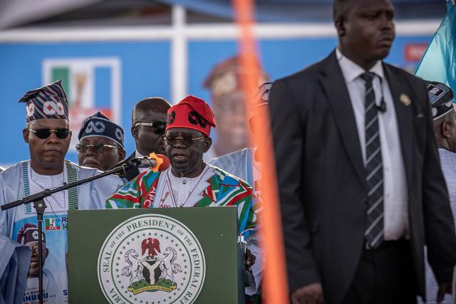 Bola Ahmed Tinubu (C), Nigeria's President, addresses supporters as Kashim Shettima (L), Vice president of Nigeria looks on during the All Progressives Congress (APC) party presidential campaign flag-off rally at the Ranchers Bees stadium in Kaduna, on Ocotber 24, 2026. President Bola Tinubu kicked off his re-election campaign Saturday promising "a better tomorrow" as Nigeria prepares to head to the polls in a vote set to be defined by the rising cost of living.
"We have prosperity, consistency, growth, recovery and opportunity" Tinubu, who has staked his first term on wide-ranging but grueling economic reforms, told a crowded rally in northwestern Kaduna state.
Since his 2023 election, Tinubu has overhauled the tax code, liberalised the exchange rate and ended a costly fuel subsidy that was bleeding the finances of the country, which pumps millions of barrels of crude per day but refines little domestically. (Photo by Light Oriye Tamunotonye / AFP)