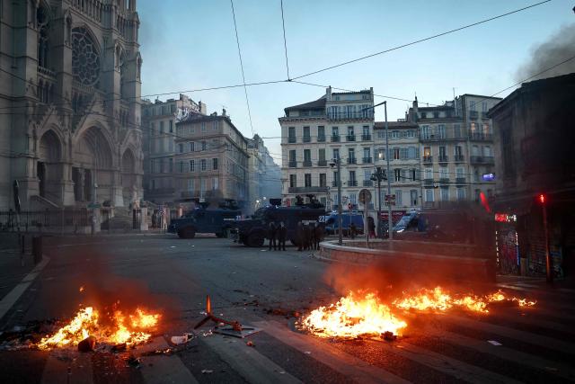 French gendarmerie alongside a "Centaure" multipurpose intervention vehicles (VIPG) face protesters in front of the Eglise Saint-Vincent de Paul during a demonstration in favor of purchasing power, the protection of public services, and fiscal and social justice, in Marseille, southeastern France on October 24, 2026 as part of a nationwide call for mobilisation bringing together former members of the Yellow Vest movement, labor unions, high school and university students. Protests by high school students over learning conditions sparked a movement that has since spread nationwide, fuelled by broader anger over the rising cost of living. About 70,000 security personnel will be deployed on October 24, 2026, Interior Minister said at a news conference, warning that calls for violence and looting were circulating on social media. (Photo by Thibaud MORITZ / AFP)