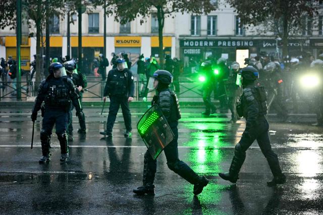 Police officers face protesters near Porte de Vincennes during a demonstration in favor of purchasing power, the protection of public services, and fiscal and social justice, in Paris on October 24, 2026 as part of a nationwide call for mobilisation bringing together former members of the Yellow Vest movement, labor unions, high school and university students. Protests by high school students over learning conditions sparked a movement that has since spread nationwide, fuelled by broader anger over the rising cost of living. About 70,000 security personnel will be deployed on October 24, 2026, Interior Minister said at a news conference, warning that calls for violence and looting were circulating on social media. (Photo by NICOLAS TUCAT / AFP)