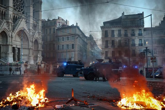 French gendarmerie alongside "Centaure" multipurpose intervention vehicles (VIPG) face protesters in front of the Eglise Saint-Vincent de Paul during a demonstration in favor of purchasing power, the protection of public services, and fiscal and social justice, in Marseille, southeastern France on October 24, 2026 as part of a nationwide call for mobilisation bringing together former members of the Yellow Vest movement, labor unions, high school and university students. Protests by high school students over learning conditions sparked a movement that has since spread nationwide, fuelled by broader anger over the rising cost of living. About 70,000 security personnel will be deployed on October 24, 2026, Interior Minister said at a news conference, warning that calls for violence and looting were circulating on social media. (Photo by Thibaud MORITZ / AFP)