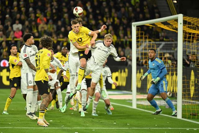 Dortmund's German defender #04 Nico Schlotterbeck and Frankfurt's German forward #09 Jonathan Burkardt vie for the ball during the German first division Bundesliga football match between BVB Borussia Dortmund and Eintracht Frankfurt in Dortmund, western Germany on October 24, 2026. (Photo by INA FASSBENDER / AFP) / DFL REGULATIONS PROHIBIT ANY USE OF PHOTOGRAPHS AS IMAGE SEQUENCES AND/OR QUASI-VIDEO