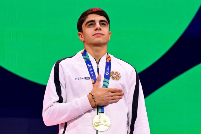 Gold medallist Armenia's Hamlet Manukyan celebrates on the podium after the Men's Pommel Horse Final during the 54th FIG Artistic Gymnastics World Championships, in Rotterdam, southern Netherlands, on October 24, 2026. (Photo by JOHN THYS / AFP)