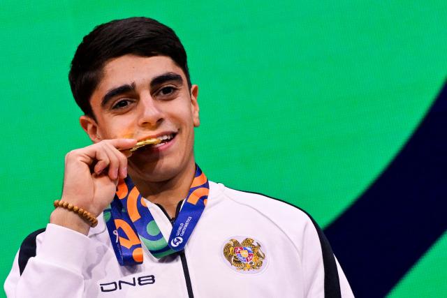 Gold medallist Armenia's Hamlet Manukyan celebrates on the podium after the Men's Pommel Horse Final during the 54th FIG Artistic Gymnastics World Championships, in Rotterdam, southern Netherlands, on October 24, 2026. (Photo by JOHN THYS / AFP)