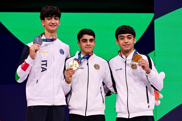 (From L) Silver medallist Italy's Gabriele Targhetta, gold medallist Armenia's Hamlet Manukyan and bronze medallist Armenia's Mamikon Khachatryan celebrate on the podium after the Men's Pommel Horse Final during the 54th FIG Artistic Gymnastics World Championships, in Rotterdam, southern Netherlands, on October 24, 2026. (Photo by JOHN THYS / AFP)