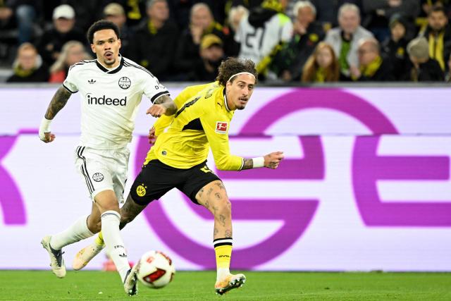 Frankfurt's Portuguese defender #24 Aurelio Buta (L) and Dortmund's Portuguese forward #21 Fabio Silva vie for the ball during the German first division Bundesliga football match between BVB Borussia Dortmund and Eintracht Frankfurt in Dortmund, western Germany on October 24, 2026. (Photo by INA FASSBENDER / AFP) / DFL REGULATIONS PROHIBIT ANY USE OF PHOTOGRAPHS AS IMAGE SEQUENCES AND/OR QUASI-VIDEO
