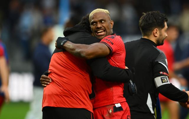Lyon's Fijian winger Jiuta Wainiqolo (R) and French head-coach Karim Ghezal celebrate after their victory in the French Top14 rugby union match between Aviron Bayonnais (Bayonne) and LOU Rugby (Lyon) at the Jean-Dauger stadium in Bayonne, south-western France on October 24, 2026. (Photo by Gaizka IROZ / AFP)