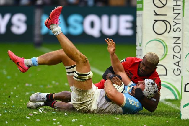 Bayonne's French number eight Esteban Capilla is tackled by Lyon's Fijian winger Jiuta Wainiqolo during the French Top14 rugby union match between Aviron Bayonnais (Bayonne) and LOU Rugby (Lyon) at the Jean-Dauger stadium in Bayonne, south-western France on October 24, 2026. (Photo by Gaizka IROZ / AFP)