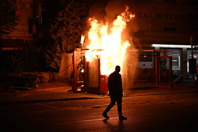 A structure burns as riot police operates to disperse protesters during a national anti-government demonstration - called by the student-led protest movement to demand better support for education and prime minister's resignation, in central Tirana on October 24, 2026. (Photo by Armend NIMANI / AFP)