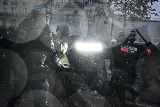 BRAV brigades police clash with protesters near Porte de Vincennes during a demonstration in favor of purchasing power, the protection of public services, and fiscal and social justice, in Paris on October 24, 2026 as part of a nationwide call for mobilisation bringing together former members of the Yellow Vest movement, labor unions, high school and university students. Protests by high school students over learning conditions sparked a movement that has since spread nationwide, fuelled by broader anger over the rising cost of living. About 70,000 security personnel will be deployed on October 24, 2026, Interior Minister said at a news conference, warning that calls for violence and looting were circulating on social media. (Photo by Aris MESSINIS / AFP)