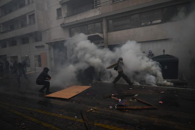 Protesters clash with police near Porte de Vincennes during a demonstration in favor of purchasing power, the protection of public services, and fiscal and social justice, in Paris on October 24, 2026 as part of a nationwide call for mobilisation bringing together former members of the Yellow Vest movement, labor unions, high school and university students. Protests by high school students over learning conditions sparked a movement that has since spread nationwide, fuelled by broader anger over the rising cost of living. About 70,000 security personnel will be deployed on October 24, 2026, Interior Minister said at a news conference, warning that calls for violence and looting were circulating on social media. (Photo by Aris MESSINIS / AFP)