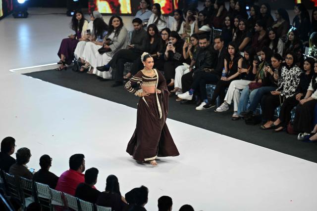 A model presents a creation by fashion designer Izna Hamza during the a LAAM Fashion Week in Lahore on October 24, 2026. (Photo by Arif ALI / AFP)