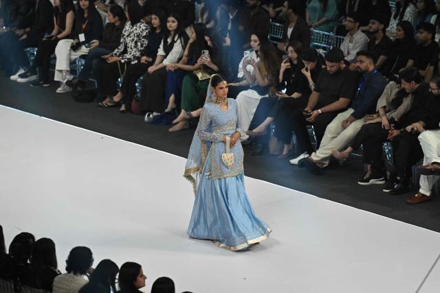 A model presents a creation by fashion designer Izna Hamza during the a LAAM Fashion Week in Lahore on October 24, 2026. (Photo by Arif ALI / AFP)