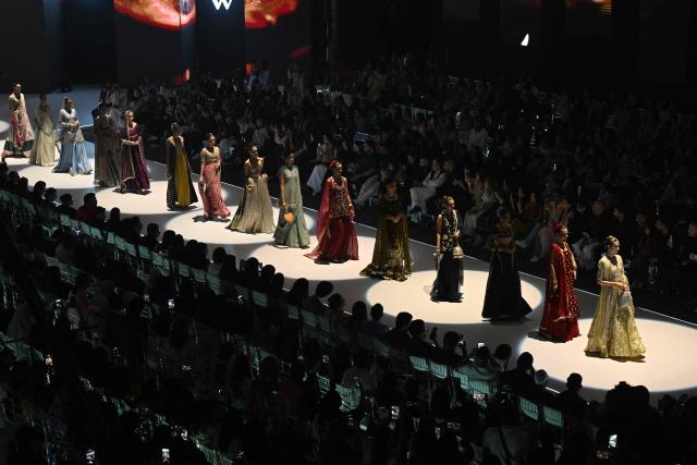 Models present creations by fashion designer Izna Hamza during the a LAAM Fashion Week in Lahore on October 24, 2026. (Photo by Arif ALI / AFP)