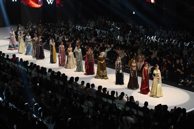 Models present creations by fashion designer Izna Hamza during the a LAAM Fashion Week in Lahore on October 24, 2026. (Photo by Arif ALI / AFP)