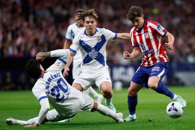 Deportivo La Coruna's Uruguayan defender #20 Jose Gimenez tackles Atletico Madrid's Argentine forward #19 Julian Alvarez during the Spanish league football match between Club Atletico de Madrid and RC Deportivo de la Coruna at Metropolitano Stadium in Madrid on October 24, 2026. (Photo by Oscar DEL POZO / AFP)