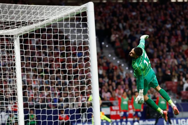 Deportivo La Coruna's Spanish goalkeeper #13 Leo Roman leaps as the shot goes over the crossbar during the Spanish league football match between Club Atletico de Madrid and RC Deportivo de la Coruna at Metropolitano Stadium in Madrid on October 24, 2026. (Photo by Oscar DEL POZO / AFP)