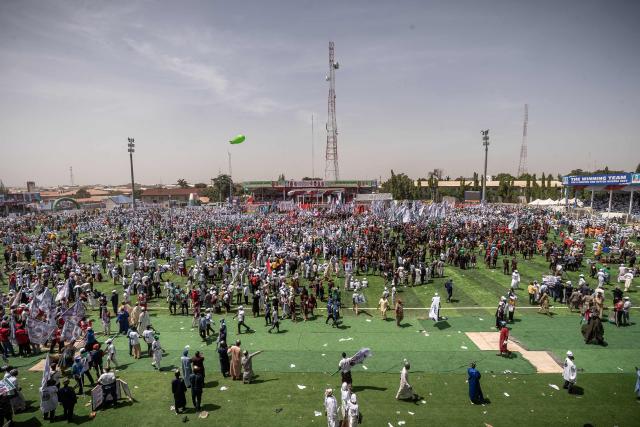 Supporters of the All Progressives Congress (APC) gather during the presidential campaign flag-off rally at the Ranchers Bees stadium in Kaduna, on October 24, 2026. Nigerian President Bola Tinubu launches his re-election campaign on Saturday facing voter anger over insecurity and economic hardships. (Photo by Light Oriye Tamunotonye / AFP)