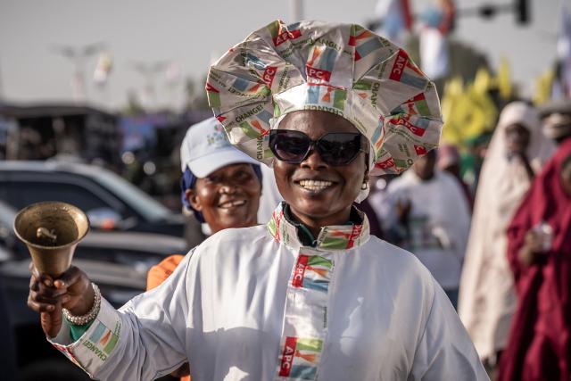 A supporter of the All Progressives Congress (APC) rings a bell during a presidential campaign flag-off rally at the Ranchers Bess stadium in Kaduna, on October 24, 2026. Nigerian President Bola Tinubu launches his re-election campaign on Saturday facing voter anger over insecurity and economic hardships. (Photo by Light Oriye Tamunotonye / AFP)