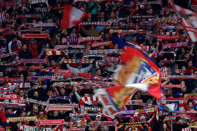 Atletico Madrid fans hold up their scarves during the Spanish league football match between Club Atletico de Madrid and RC Deportivo de la Coruna at Metropolitano Stadium in Madrid on October 24, 2026. (Photo by Oscar DEL POZO / AFP)