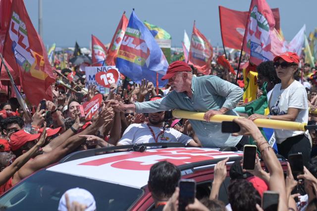 Brazil's President and presidential candidate Luiz Inacio Lula da Silva greets supporters during a campaign rally on Copacabana beach in Rio de Janeiro, Brazil on October 24, 2026, ahead of the presidential election runoff. (Photo by TERCIO TEIXEIRA / AFP)