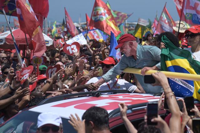 Brazil's President and presidential candidate Luiz Inacio Lula da Silva greets supporters during a campaign rally on Copacabana beach in Rio de Janeiro, Brazil on October 24, 2026, ahead of the presidential election runoff. (Photo by TERCIO TEIXEIRA / AFP)