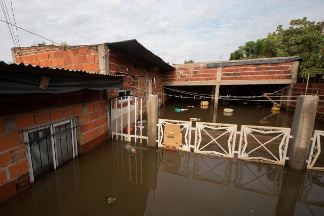 A flooded house is pictured after the overflow of the Parana river, following heavy rainfall and the opening of the floodgates at the Yacyreta hydroelectric dam, in Corrientes, Argentina on October 23, 2026. More than 2,000 people have been forced to leave their homes due to flooding linked to the El Nino climate phenomenon affecting northeastern Argentina. The emergency caused two deaths last weekend and is expected to persist for the coming months. Heavy rainfall in recent weeks has dangerously increased water levels in the Iguazu, Parana, and Uruguay rivers, which run along northeastern Argentina, forming natural borders with Brazil, Paraguay, and Uruguay before flowing into the Rio de la Plata. (Photo by Joaquin Meabe / AFP)