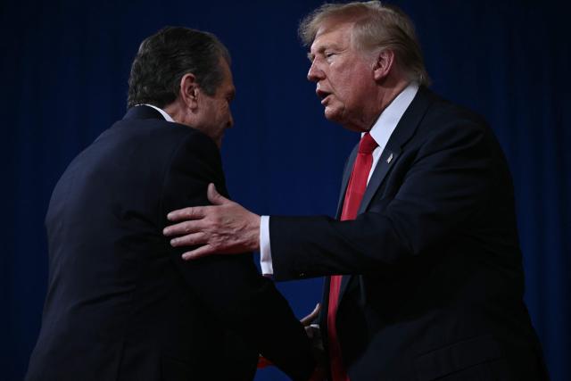 US President Donald Trump greets Georgia gubernatorial candidate Rick Jackson at a midterm election campaign rally at Guardian Centers of Georgia in Perry, Georgia on October 24, 2026. President Trump is traveling around the country to try to give a boost to Republicans in tight midterm races. (Photo by Brendan SMIALOWSKI / AFP)