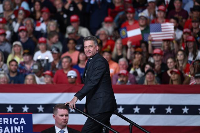 CEO of Audi AG Gernot Dollner walks on stage at a midterm election campaign rally at Guardian Centers of Georgia in Perry, Georgia on October 24, 2026. President Trump is traveling around the country to try to give a boost to Republicans in tight midterm races. (Photo by Brendan SMIALOWSKI / AFP)