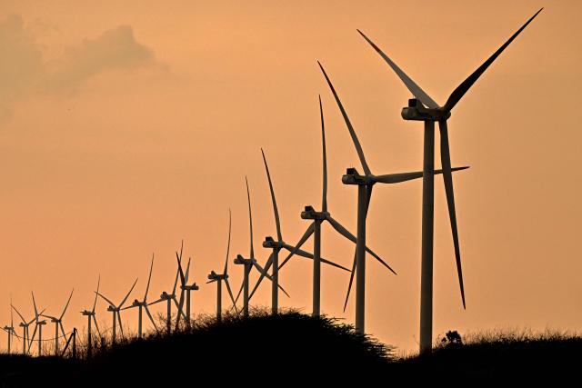 This photograph taken on October 2, 2026 shows wind turbines installed in Sri Lanka's Mannar Peninsula. The government aims to generate 70 percent of the country's electricity from renewable sources by 2030, including wind power. But it has frozen new projects in Mannar to ease local opposition. Since they appeared six years ago, the Mannar wind turbines have been blamed for a host of problems -- from dwindling catches to floods, fuelling opposition to green energy projects as fuel costs soar. (Photo by Ishara S. KODIKARA / AFP)