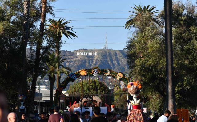 People in costume attend Hollywood Forever Cemetery's 27th annual Dia De Los Muertos event on October 24, 2026. (Photo by Chris DELMAS / AFP)