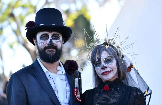People in costume attend Hollywood Forever Cemetery's 27th annual Dia De Los Muertos event on October 24, 2026. (Photo by Chris DELMAS / AFP)