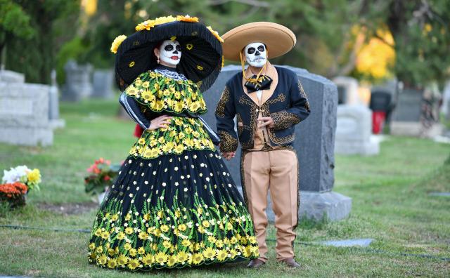 People in costume attend Hollywood Forever Cemetery's 27th annual Dia De Los Muertos event on October 24, 2026. (Photo by Chris DELMAS / AFP)