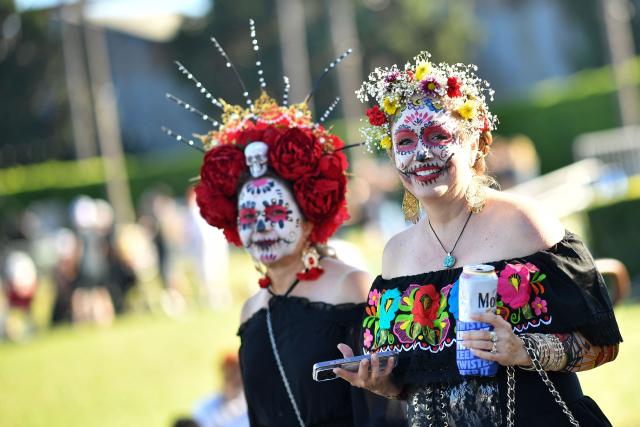 People in costume attend Hollywood Forever Cemetery's 27th annual Dia De Los Muertos event on October 24, 2026. (Photo by Chris DELMAS / AFP)