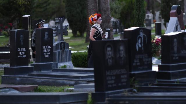 People in costume attend Hollywood Forever Cemetery's 27th annual Dia De Los Muertos event on October 24, 2026. (Photo by Chris DELMAS / AFP)