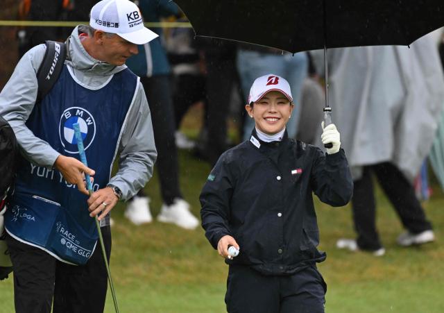 Yuri Yoshida of Japan smiles after a birdie putt on the 5th hole during the final round of the LPGA Tour - BMW Ladies Championship golf tournament at Pine Beach Golf Links in Haenam on October 25, 2026. (Photo by Jung Yeon-je / AFP)