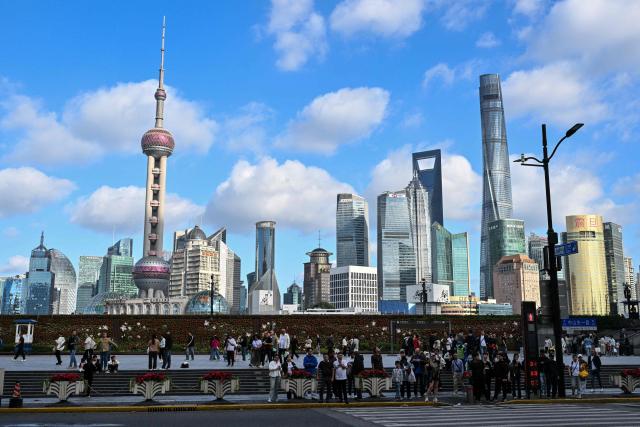 People visit The Bund promenade in Shanghai on October 25, 2026. (Photo by Hector RETAMAL / AFP)