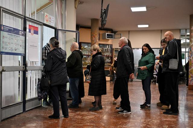 Voters queue outside a polling station to cast their ballots for Serbia's snap parliamentary elections in Belgrade on October 25, 2026. The vote is the culmination of nearly two years of student-led protests sparked by the 2024 collapse of a canopy at Novi Sad railway station that killed 16 people, a tragedy widely blamed on corruption. (Photo by Andrej ISAKOVIC / AFP)