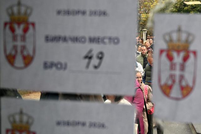 Voters queue outside a polling station to cast their ballots for Serbia's snap parliamentary elections in Belgrade on October 25, 2026. The vote is the culmination of nearly two years of student-led protests sparked by the 2024 collapse of a canopy at Novi Sad railway station that killed 16 people, a tragedy widely blamed on corruption. (Photo by Andrej ISAKOVIC / AFP)