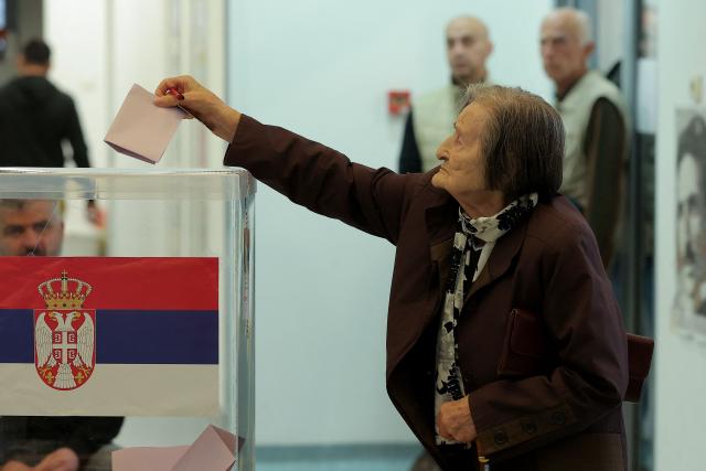 A voter casts a ballot at a polling station for Serbia's snap parliamentary elections in Belgrade on October 25, 2026. The vote is the culmination of nearly two years of student-led protests sparked by the 2024 collapse of a canopy at Novi Sad railway station that killed 16 people, a tragedy widely blamed on corruption. (Photo by Pedja Milosavljevic / AFP)