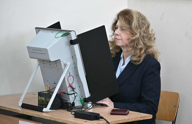 Bulgaria's incumbent President and Presidential candidate Iliana Iotova uses a voting machine to prepare a ballot to vote for the presidential election at a polling station in Sofia, on October 25, 2026. Bulgarians are voting in a presidential election on October 25, as security concerns swirl following a series of drone attacks on ships in the Black Sea. The incumbent President, who favors dialogue with Moscow and opposes military aid to Ukraine, is the frontrunner for a new term in the largely ceremonial post, polls show. (Photo by Nikolay DOYCHINOV / AFP)