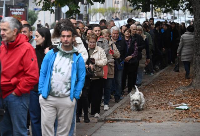 Voters queue at a polling station to cast their ballots for Serbia's snap parliamentary elections in Belgrade on October 25, 2026. The vote is the culmination of nearly two years of student-led protests sparked by the 2024 collapse of a canopy at Novi Sad railway station that killed 16 people, a tragedy widely blamed on corruption. (Photo by OLIVER BUNIC / AFP)