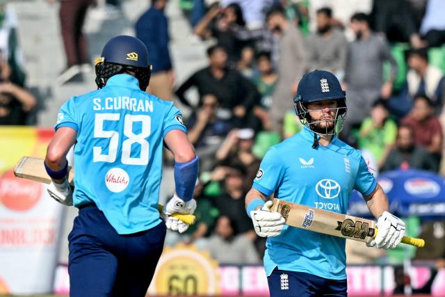 England's Ben Duckett (R) and Sam Curran run between the wickets during the one-day international (ODI) tri-series cricket match between Pakistan and England at the Gaddafi Stadium in Lahore on October 25, 2026. (Photo by ARIF ALI / AFP)
