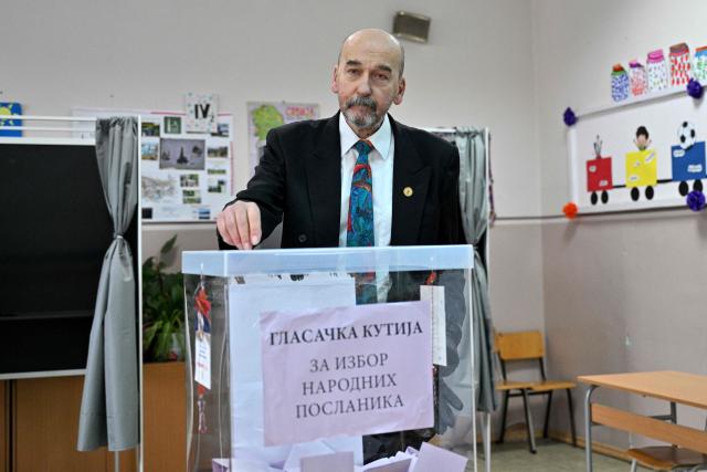 Radomir Saicic, a chemistry professor and candidate on the student-backed electoral list, casts his ballot at a polling station in Belgrade on October 25, 2026, during Serbia's snap parliamentary elections. The vote is the culmination of nearly two years of student-led protests sparked by the 2024 collapse of a canopy at Novi Sad railway station that killed 16 people, a tragedy widely blamed on corruption. (Photo by Andrej ISAKOVIC / AFP)