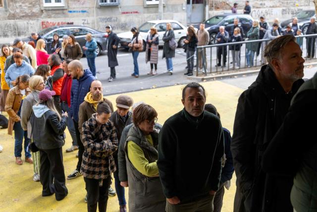 Voters queue at a polling station to cast their ballots for Serbia's snap parliamentary elections in Belgrade on October 25, 2026. The vote is the culmination of nearly two years of student-led protests sparked by the 2024 collapse of a canopy at Novi Sad railway station that killed 16 people, a tragedy widely blamed on corruption. (Photo by Milos Milanovic / AFP)