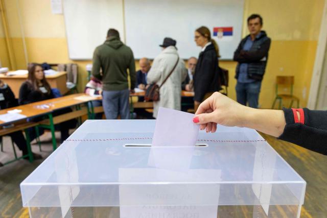 A voter casts a ballot at a polling station for Serbia's snap parliamentary elections in Belgrade on October 25, 2026. The vote is the culmination of nearly two years of student-led protests sparked by the 2024 collapse of a canopy at Novi Sad railway station that killed 16 people, a tragedy widely blamed on corruption. (Photo by Milos Milanovic / AFP)