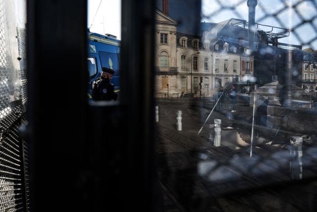 A French gendarme stands guard operating a gendarmerie chekpoint with set up barriers ahead of a demonstration "against racism, fascism and imperialism" on the sidelines of the Congress of the Far-right party Rassemblement National (RN) in Orleans, central France on October 25, 2026. On October 25, 2026, gatherings will remain banned in a large part of the Orléans urban area. But several organizations may call for people to assemble outside the prohibited zone, as the day after a congress in Orléans that passed without any major incident but under heavy police surveillance, a French far right candidate is due to deliver her first major campaign speech in the afternoon. (Photo by SIMON WOHLFAHRT / AFP)